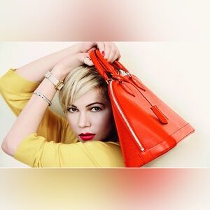 Louis Vuitton Alma handbag in Piment Epi leather PM with silver-tone hardware.